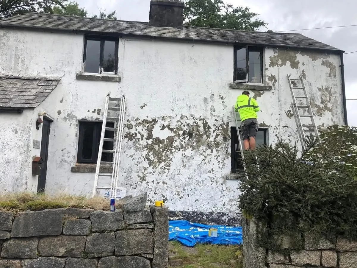 Cottage with blown, flaking render before repair in Cullompton